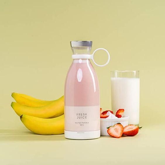 Compact mini juice blender blending berries and banana
